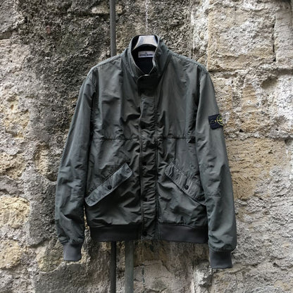 stone island ss 2013 micro reps bomber jacket in olive hanging on wall
