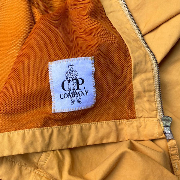 cp company label on orange jacket by moreno ferrari